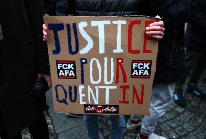 A person holds a sign as people gather to pay tribute to Quentin, an activist who died from injuries sustained during a beating on February 12 in Lyon, during a demonstration at the Place de la Sorbonne in Paris, France, February 15, 2026. REUTERS/Stephane Mahe