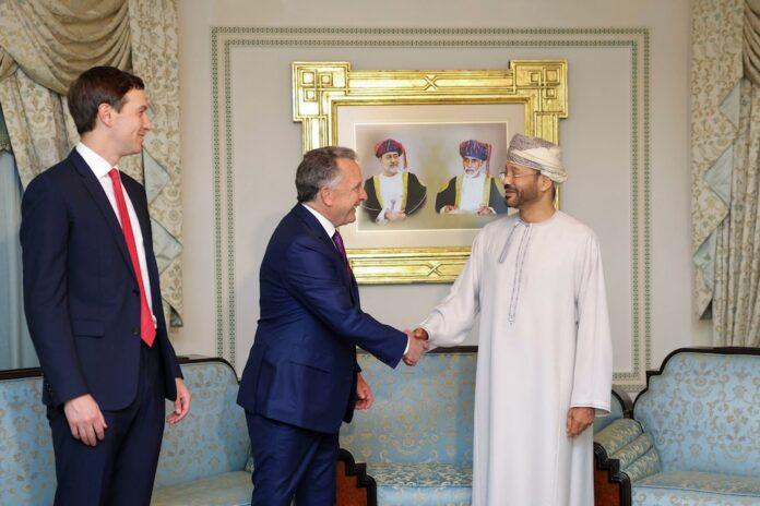 US special envoy Steve Witkoff shakes hands with Oman Foreign Minister Badr bin Hamad al-Busaidi as Jared Kushner looks on during a meeting in Muscat (Oman Foreign Ministry/AFP)