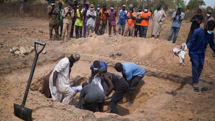 SENSITIVE MATERIAL.THIS IMAGE MAY OFFEND OR DISTURB.People place the bodies of victims of a night attack in a mass grave in Woro community, where dozens of residents were killed after gunmen stormed the village in Kaiama local government area, Kwara state, Nigeria, February 5, 2026. REUTERS/Ibrahim Ndamitso